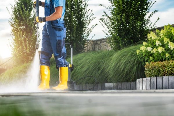 caucasian-garden-worker-pressure-washing-residenti-2023-11-27-05-13-54-utc